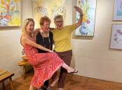 Jane Whitfield, Alita Allison and Yvonne Kiely, whoop it up after hanging their joint works. Picture supplied.