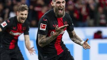 Leverkusen's Robert Andrich wheels away after his late goal kept their unbeaten streak alive. (AP PHOTO)