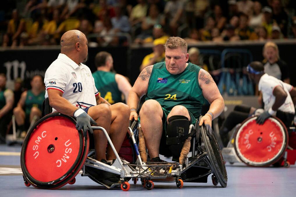  Andrew Tebbit defends the ball from a Team USA competitor at the wheelchair rugby semi-finals during the Invictus Games 2023. Picture by Ricky Fuller 