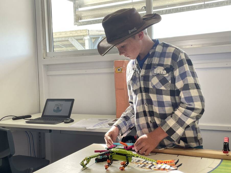 Rollands Plains Upper Public School student and team member Beren adjusts a Lego design that will be part of their Robot Run in the Asia Pacific Open Championships later this month. Picture by Mardi Borg