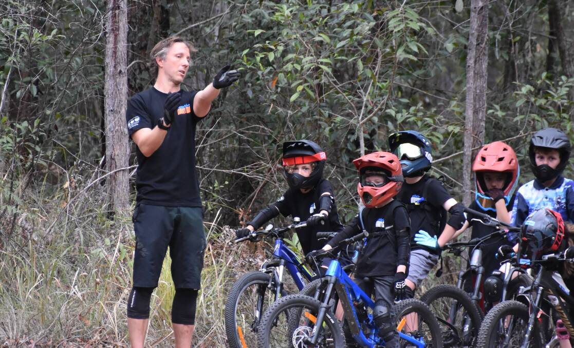 Jolly Nose Gravity Groms trainer Nathan Hall teaches the young mountain bikers the ropes. Picture by Mardi Borg