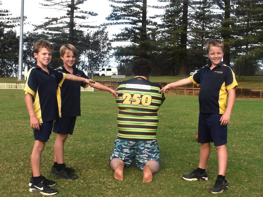 David Tunstead's children Brock, Isaac and Ollie point to the special jersey their father will be wearing when he runs out for game 250. Picture by Mardi Borg