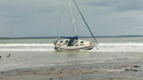Large seas led to this catamaran being washed ashore on the South Coast. Picture supplied by NSW Maritime