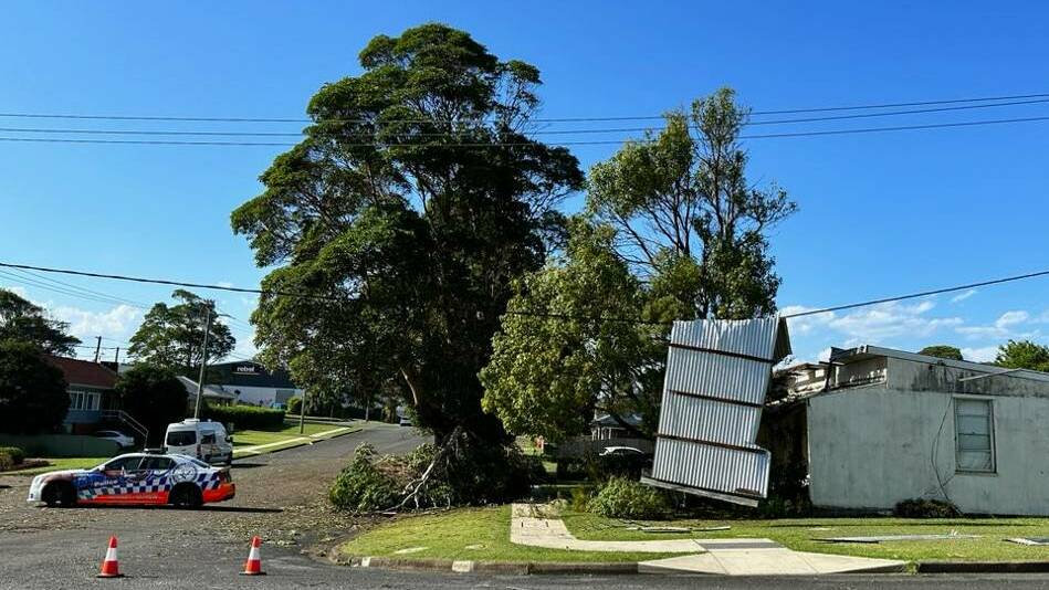 An indication of how dangerous some powerlines are following the storm. Iron sheeting was draped over this one in Table Street. Picture supplied by Essential Energy