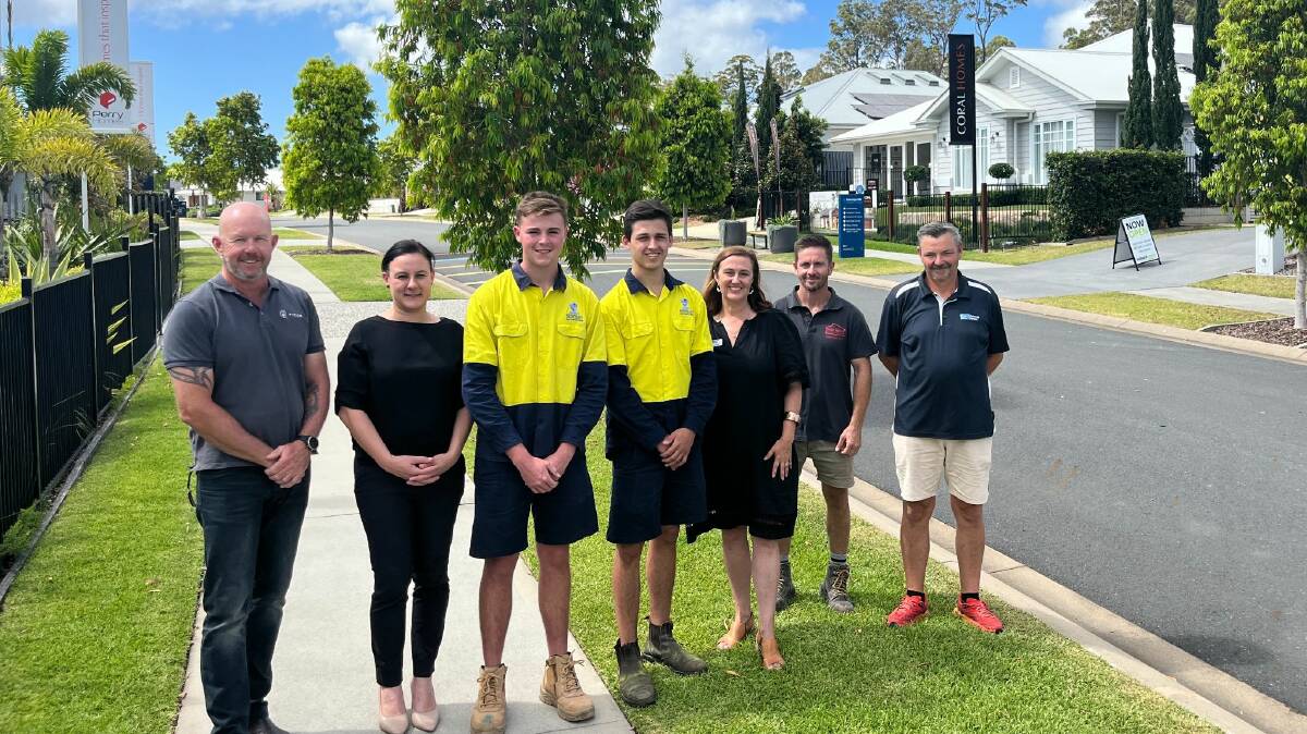 Newman Senior Technical College School-based apprentices Jack Edwards and Finlay Baker with representatives from the Sovereign Hills Display Village builders. Picture supplied.