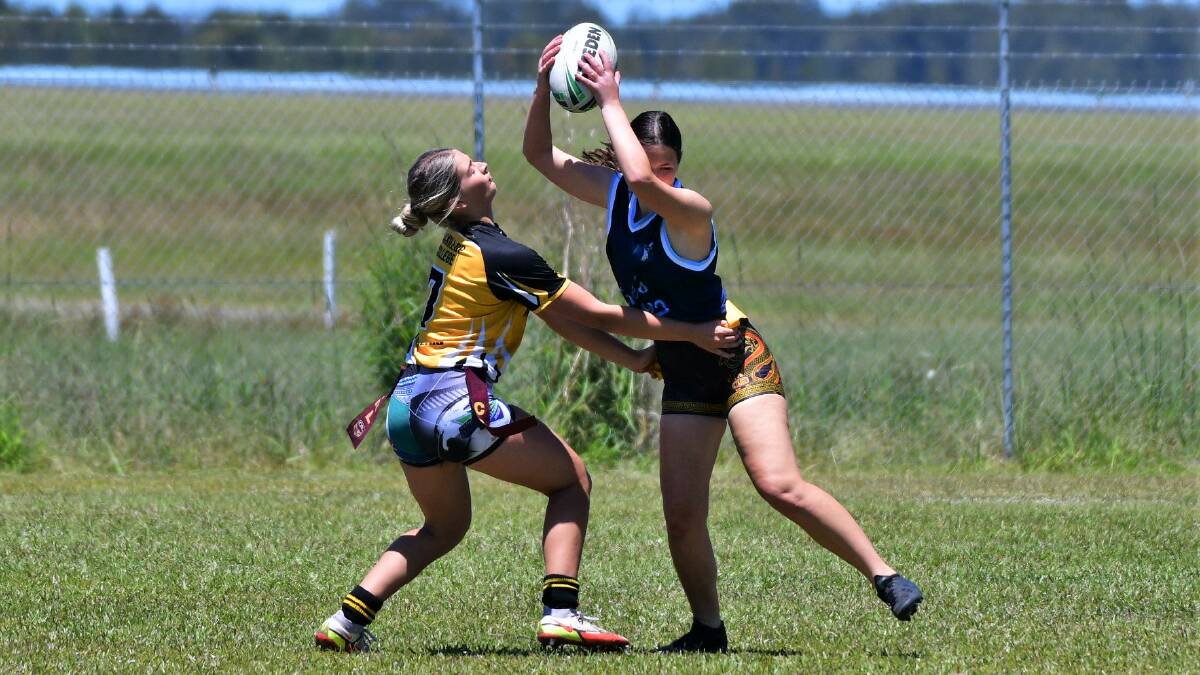 Maddie Cottrell-Dormer (left) attempts a tag for MacKillop College in the Girls League Tag Challenge. Picture by Paul Jobber