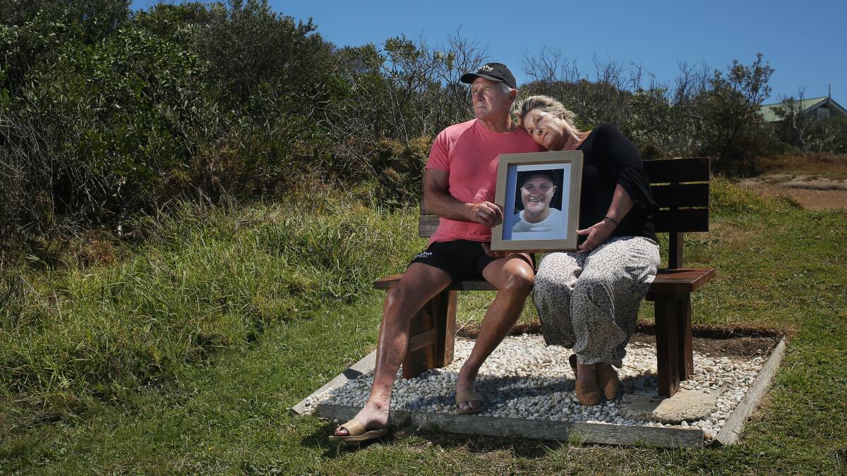 Jack's father and mother Glen and Cheryl Roberts at his memorial chair overlooking Catherine Hill Bay. Picture by Simone De Peak 