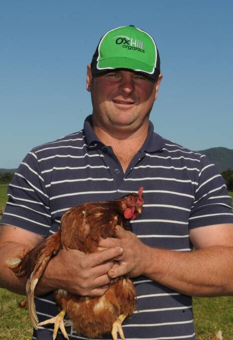 Organic: Chris Eggert holding one of his organic hens. Photo: Ivan Sajko