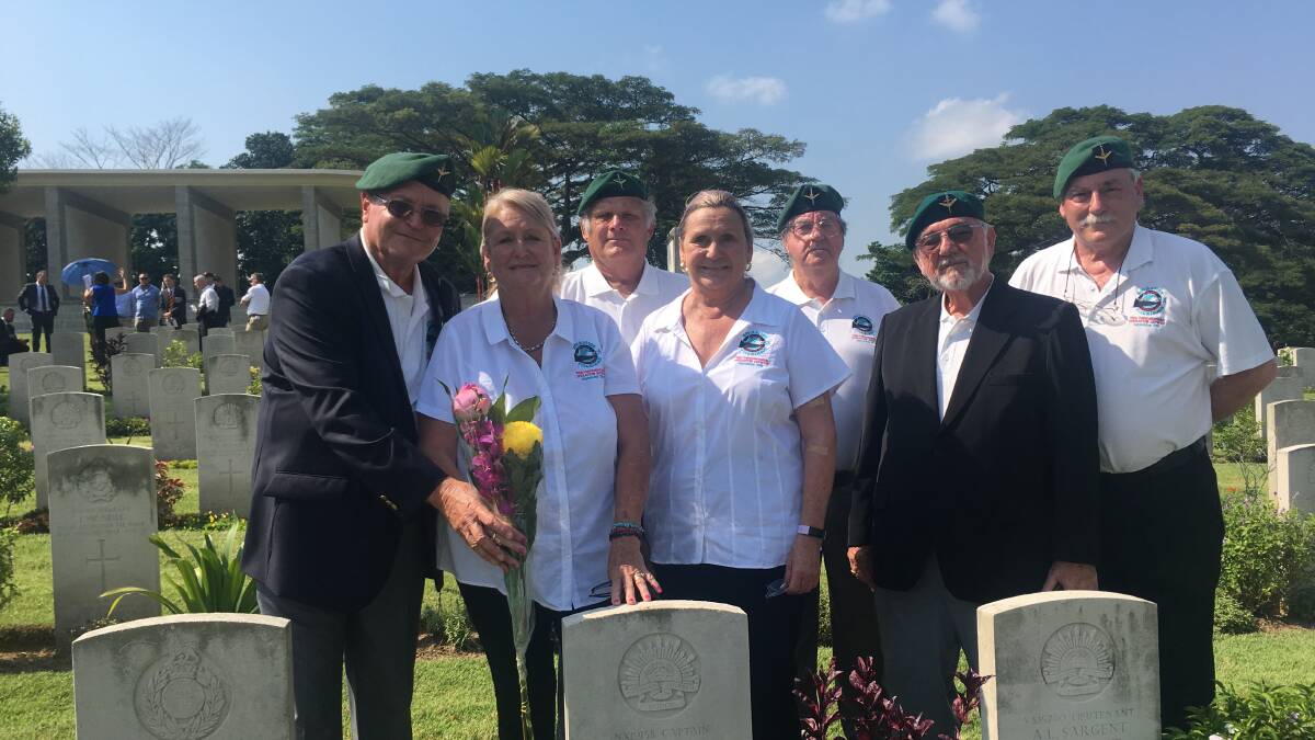 Wauchoppe's Reg Pierce, third from left standing behind the gravestone for Bob Page who was part of the Operation Jaywick and Rimau. Picture, file 