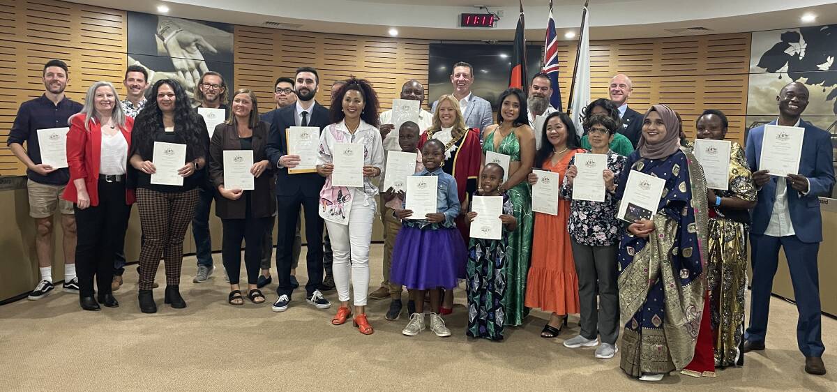 The new Australian citizens and officials gather after the citizenship ceremony. Picture by Lisa Tisdell