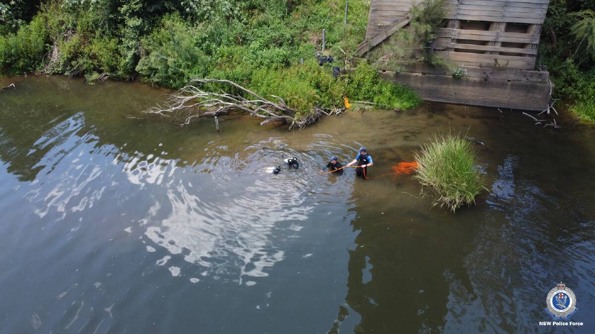 Police divers search a section of the Hastings River