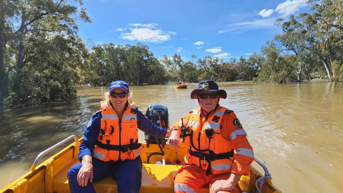 Marine Rescue Port Macquarie member Alison Cameron-Brown (left) was among the volunteers who travelled inland to help during the 2022 floods. She is pictured with a Port Stephens SES volunteer on their way to set up markers to guide the way for safe entry and exit points to the flooded Barwon River. Picture supplied