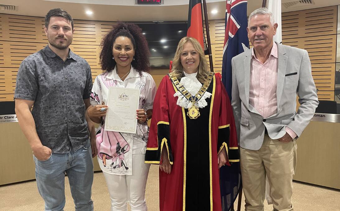 Elizete de Oliveira (second from left) displays her Australian citizenship certificate as mayor Peta Pinson (third from left), Rob Dann (left) and Colin Swadling (right) look on. Picture by Lisa Tisdell
